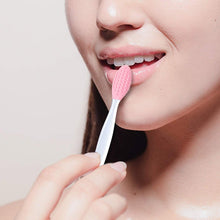Load image into Gallery viewer, A woman gently exfoliating her lips using the silicone brush.
